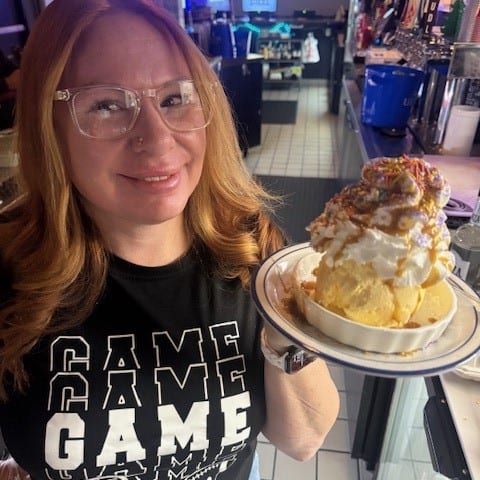 Peanut Butter & Chocolate Chunk Cookie Topped with Scoop of Vanilla Ice Cream.