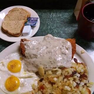 Country Fried Steak, With 2 Eggs Home Fries,topped With Sausage Gravy & Toast