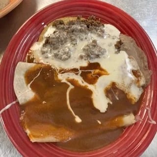 25. One Beef Burrito Topped with Cheese Dip, One Beef Enchilada & One Beef Chile Con Queso