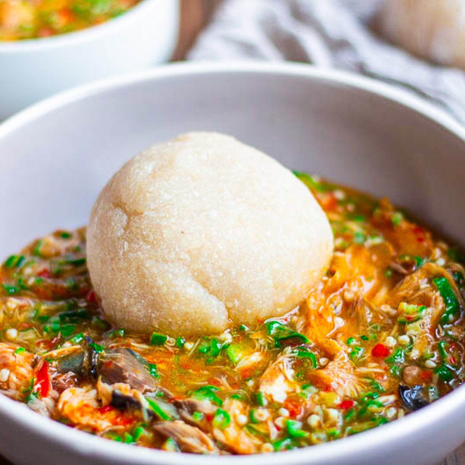 Fufu or Eba with assorted meat Okra Soup.