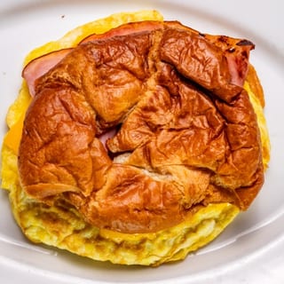 Croissant with Scrambled Egg, American Cheese, Bacon & Ham