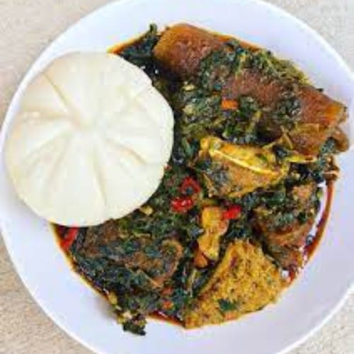 Efo riro and Pounded Yam serves with Fish or chicken.