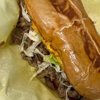 ASADA TORTA - BEANS, CHEESE, GUACAMOLE, LETTUCE, CARNE ASADA, SALSA FRESCA