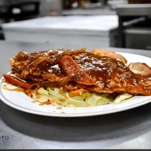 Whole Red Snapper Not Spicy Served with Jasmine Rice Cabbage and Plantains.