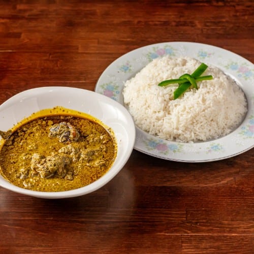 Peanut Soup with White Rice, Boiled Plantains, or White Yams.