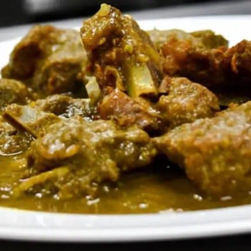 Curry Goat Served with Jasmine Rice, Cabbage and Plantains.