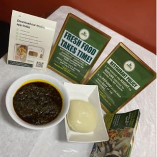 Efo Riro w/ Pounded Yam served with beef, goat, or assorted meats. 