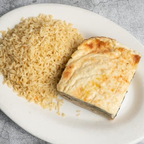 Mousaka Served with Rice Pilaf.