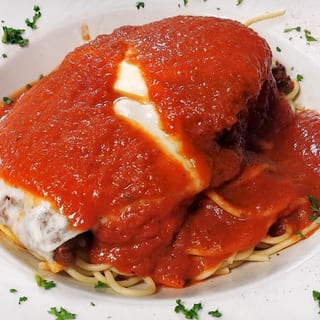Veal parmesan over pasta