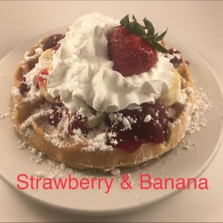 3 Fresh & Strawberry Syrup, Banana Pancakes Whipped Cream and Dusted with Powdered Sugar