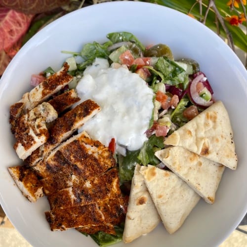 Salted. Greek Salad pictured with blackened chicken.