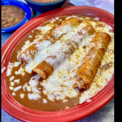 Three Sonoran Rolled Tacos Enchilada Style.