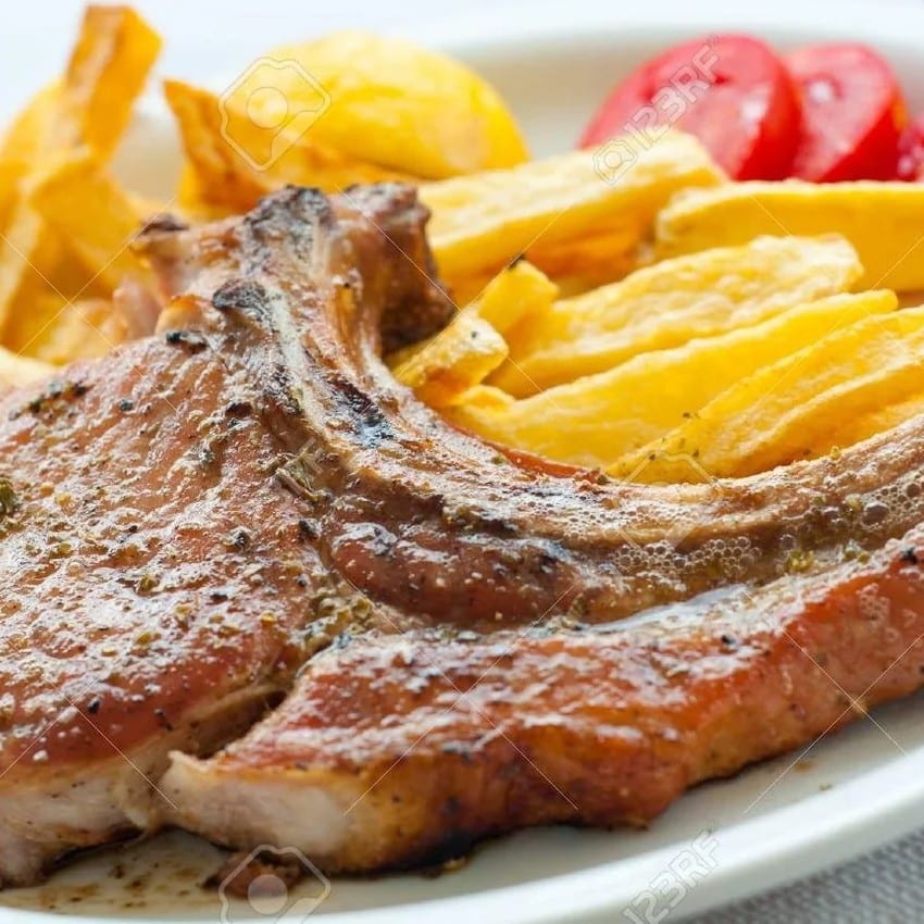 Chuletas Fritas (Pork Chops) con Yuca Frita (Fried Yuca).