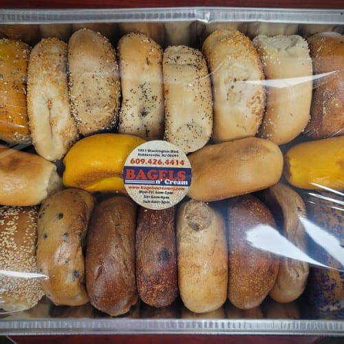 Two Dozen Bagels Sliced/Wrapped in Tray.