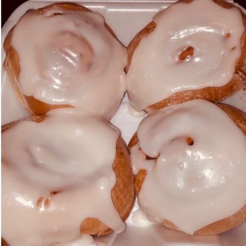Four Glazed Cinnamon Rolls.