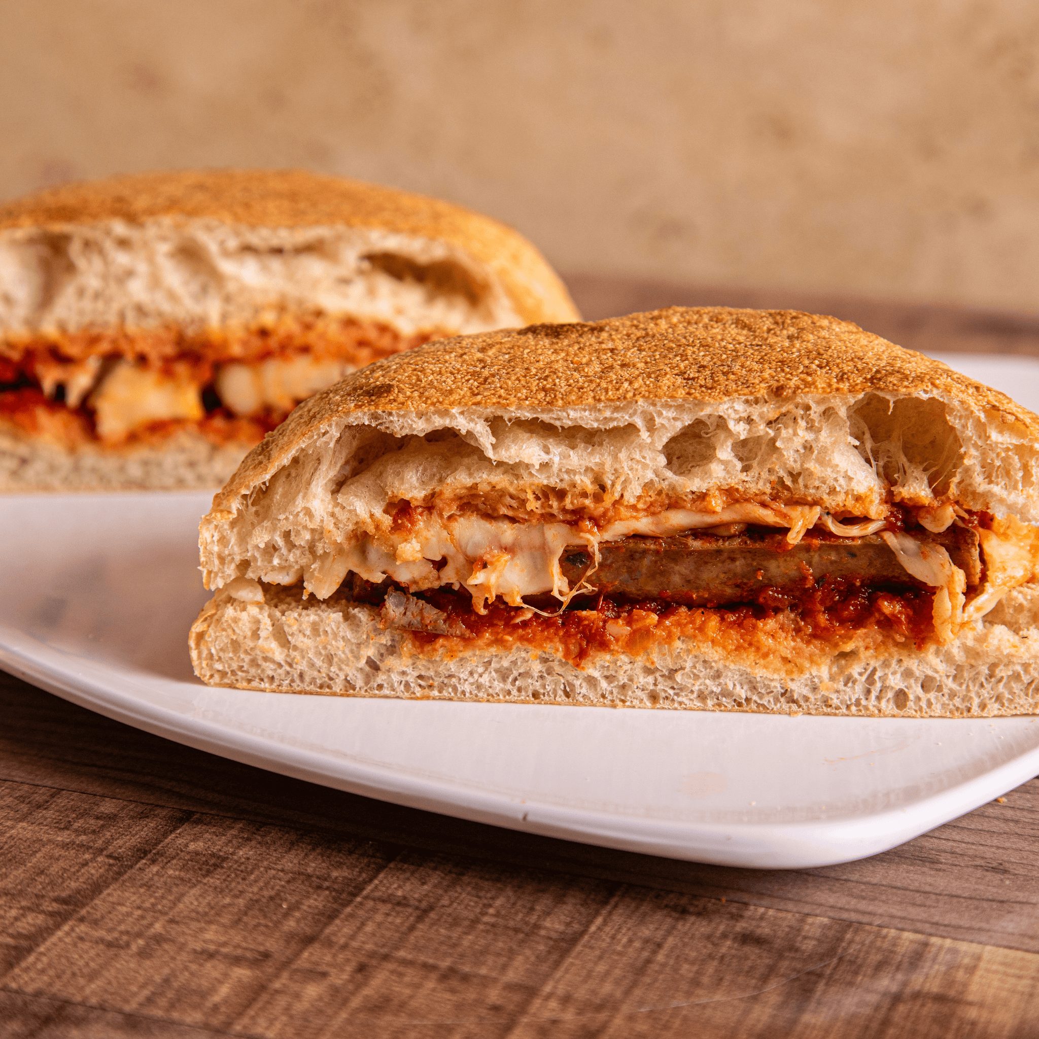 Sausage & Peppers Parmigiana Sandwich.