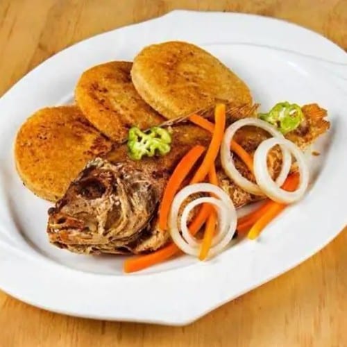 Whole Red Snapper Spicy Spicy Served with Rice & Peas or White Rice Cabbage and Plantains.