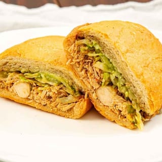 CHICKEN TORTA - BEANS, CHEESE, GUACAMOLE, LETTUCE, CHICKEN