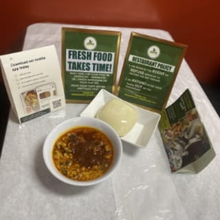 EGUSI W/ Pounded Yam fufu served with chicken or fish.