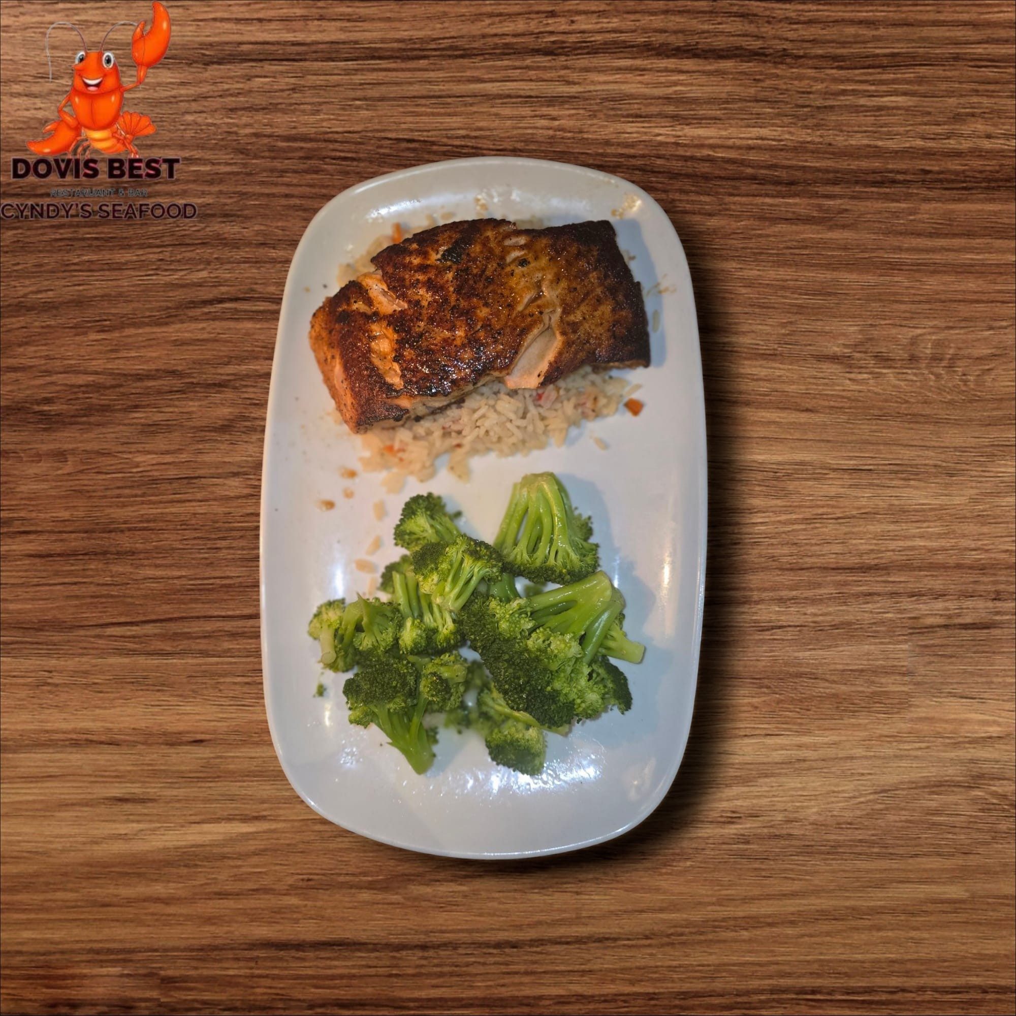 Grilled Salmon with Jallof Rice, Sauteed Broccoli, Collard Green or Spinach.