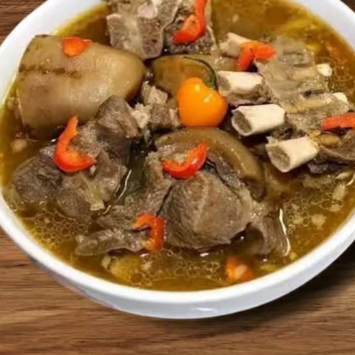 Goat Pepper Soup with White Rice, Boiled Plantains, or White Yams.