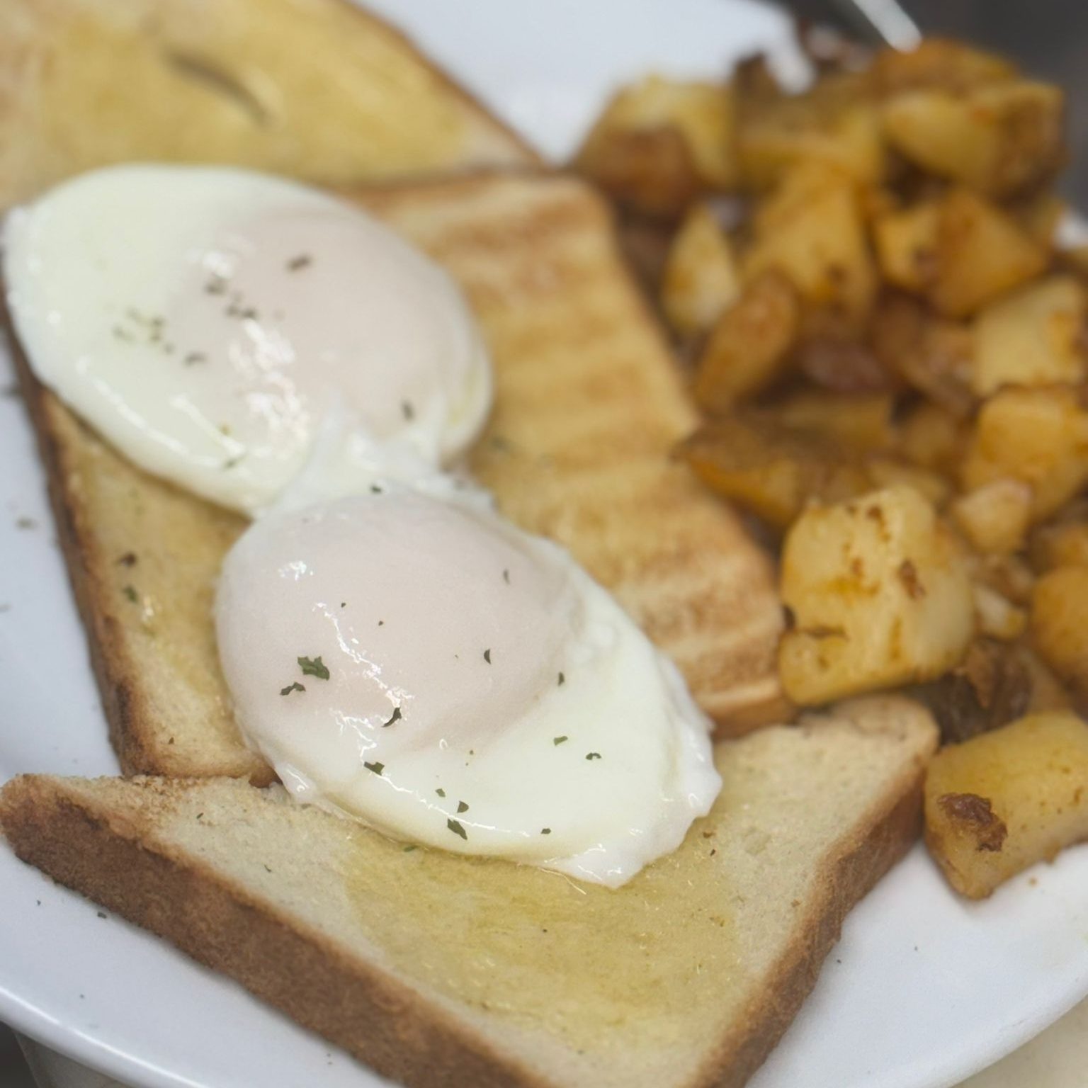 Two Poached Egg with Home Fries and Toast.