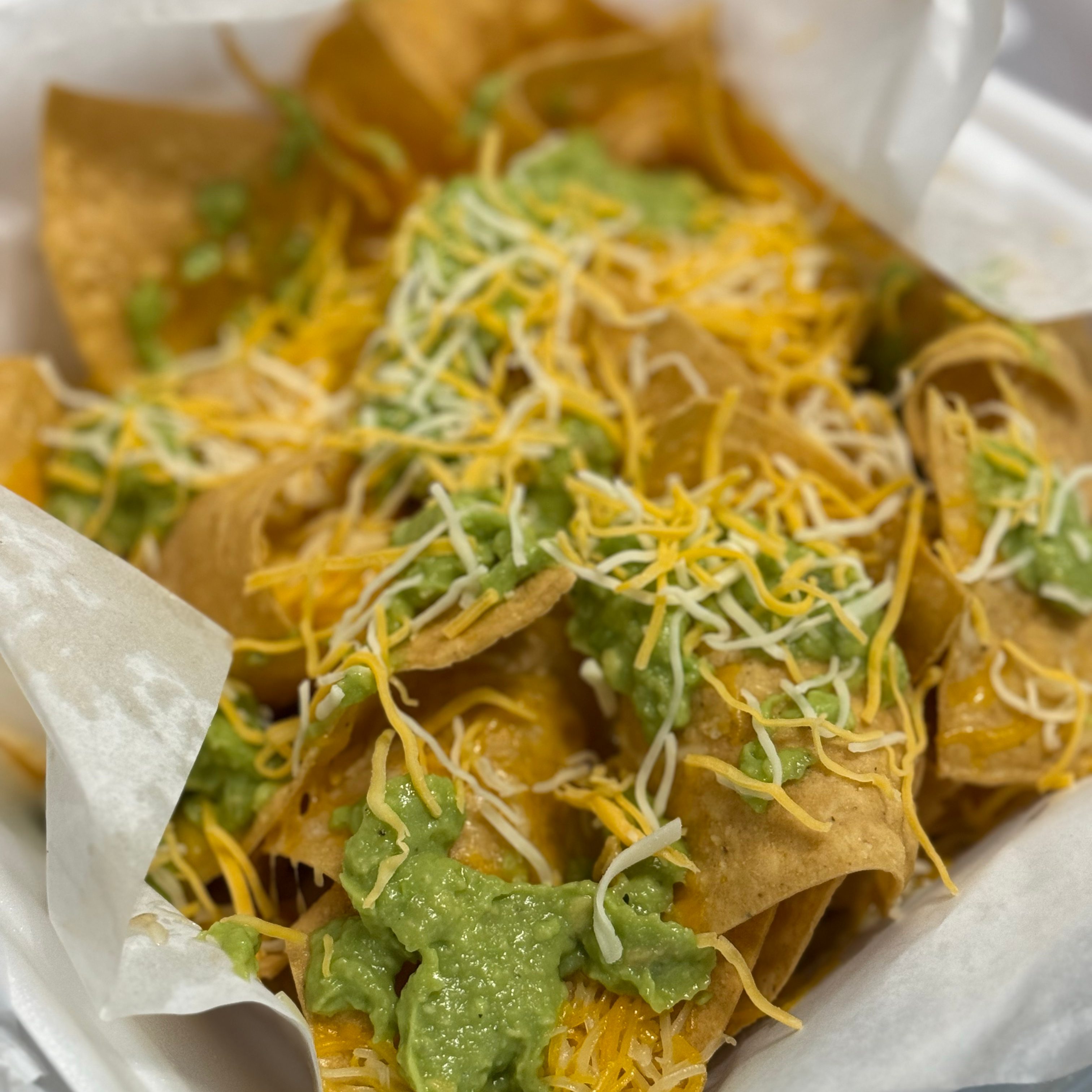 A1 Chips with Guacamole & Shredded Cheese.