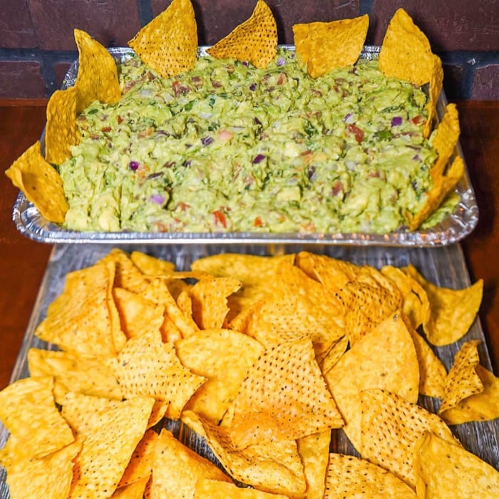 QUATER TRAY OF GUAC AND CHIPS.